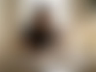 Woman tasting wine at kitchen table