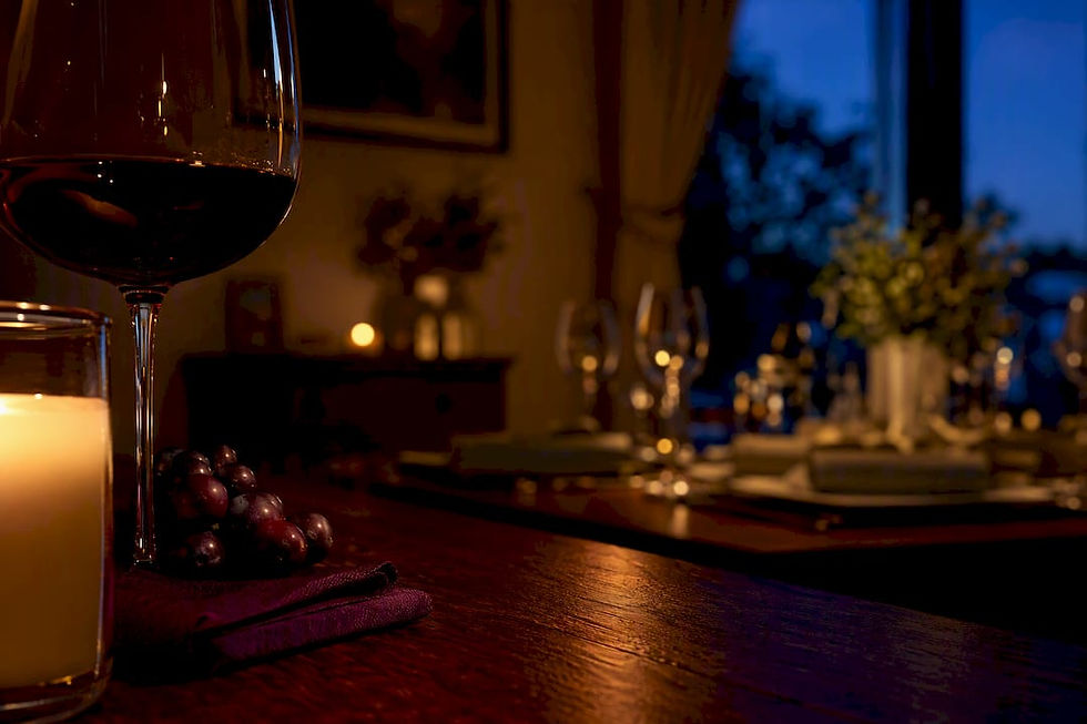 Wine candle glowing beside red wine glass
