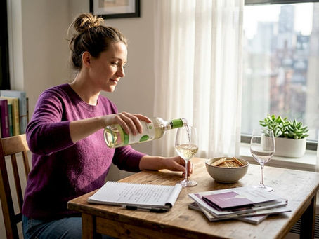 Woman learning wine tasting at kitchen table