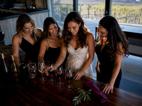Bride and friends arranging a wine tasting