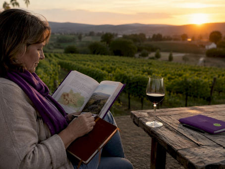 Woman studying wine appellations in cellar