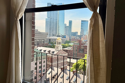 View of downtown Boston and Faneuil Hall from a window inside Boston Psychiatry Center's therapy and psychiatry office.