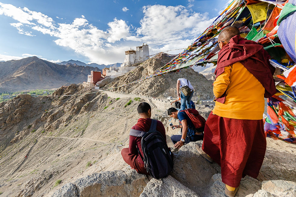 Buddhist monks overlooking Namgyal Tsemo Gompa in Leh Ladakh India