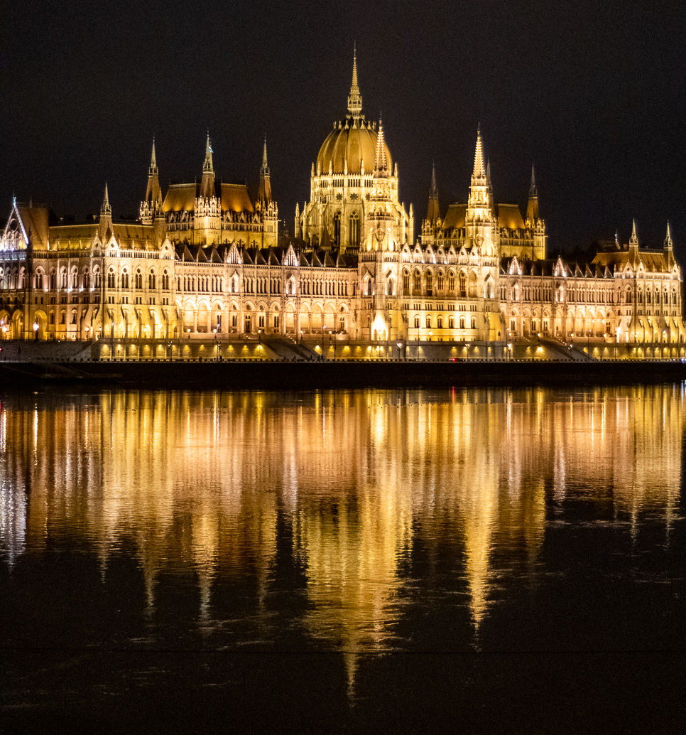 The Hungarian house of parliament in Budapest, at night and reflected in Danube river
