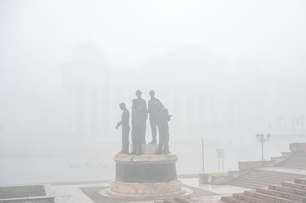 Landscape photograph of a statue hidden by smog pollution in Skopje, North Macedonia