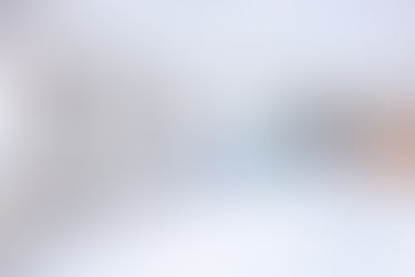 Hospital ward with patient beds, medical equipment, and nurse working