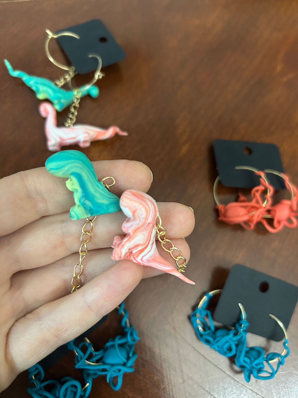 Thumbnail: Polymer clay earring sculptures: octopuses and dinosaurs currently available