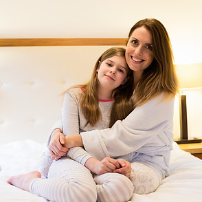 mother-embracing-daughter-bedroom.jpg