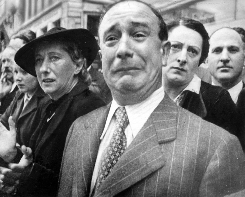 "A Frenchman sheds tears of patriotic grief as flags of his country's lost regiments are exiled to Africa", according to the caption in the 3 March 1941 issue of Life magazine. Incorrectly captioned by NARA as "A Frenchman weeps as German soldiers march into the French capital, Paris, on June 14, 1940, after the Allied armies had been driven back across France."