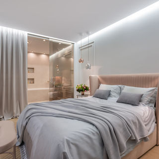Luxury bedroom interior: plush bed, ensuite bathroom