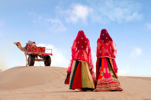 Womens standing on sand in panel lehengas