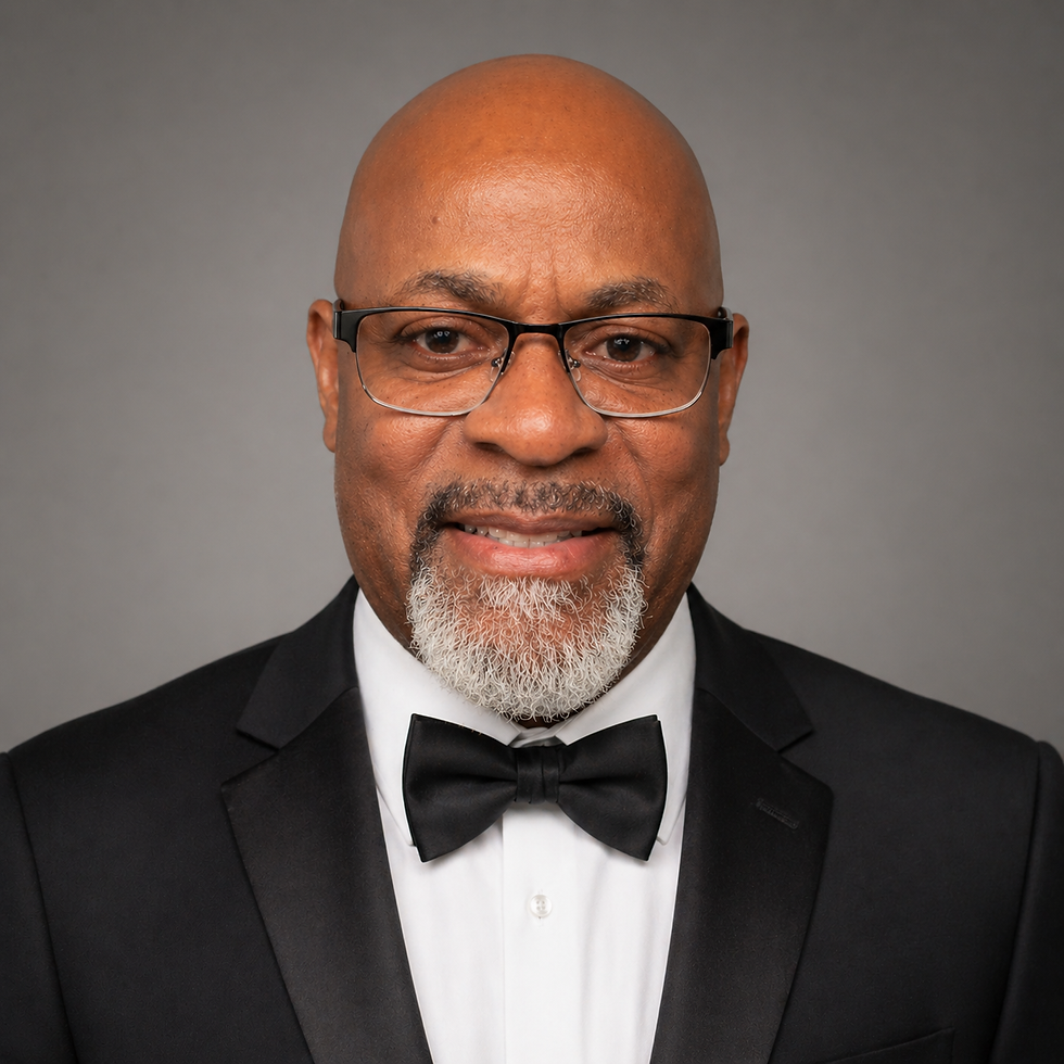 Smiling man in tuxedo with glasses and beard