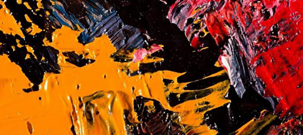 Abstract close-up of thick orange, red, black, and blue paint strokes with a glossy, energetic texture.