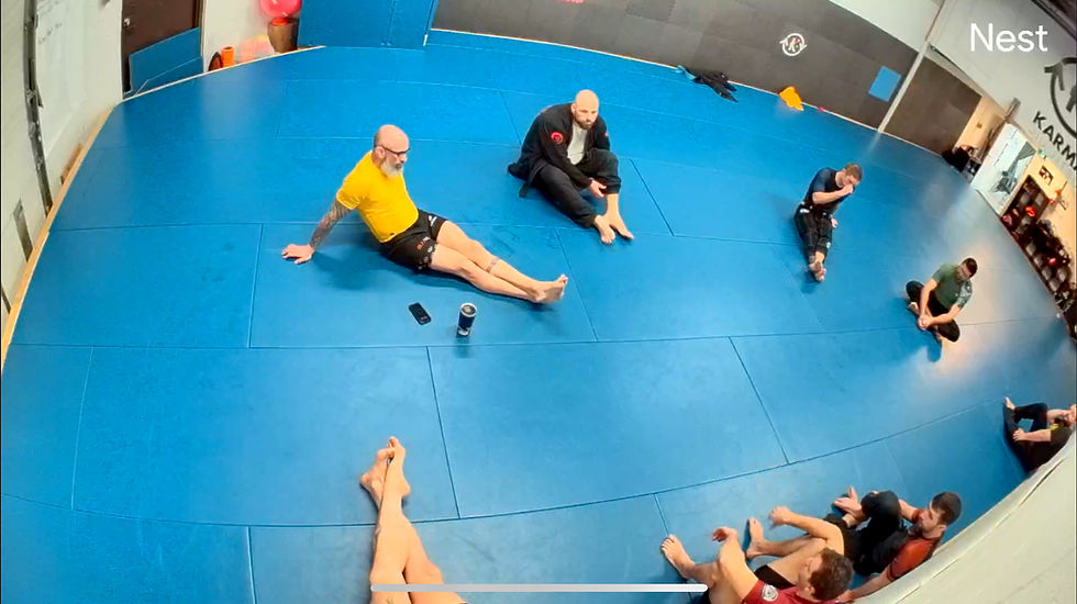 Close-up view of a Jiu Jitsu gym filled with practitioners working on their techniques