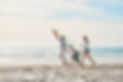 Family, holding hands and kite on beach together for holiday, travel or vacation in summer