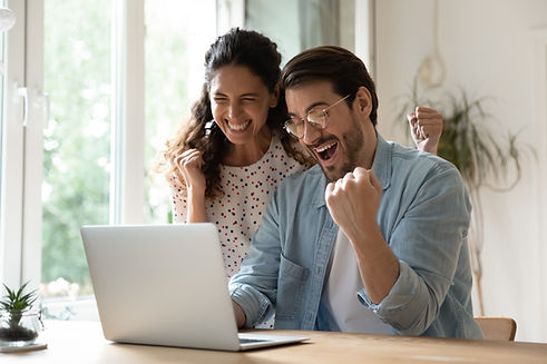 Overjoyed millennial man and woman triumph win online lottery on laptop. Happy excited you