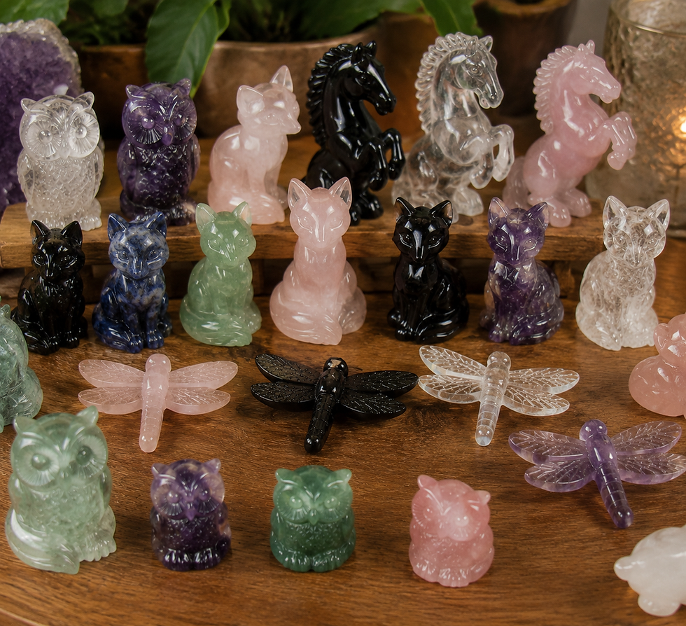 High angle view of a collection of various crystal animal carvings on a wooden table