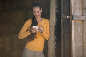 female-jockey-using-smart-phone-while-st