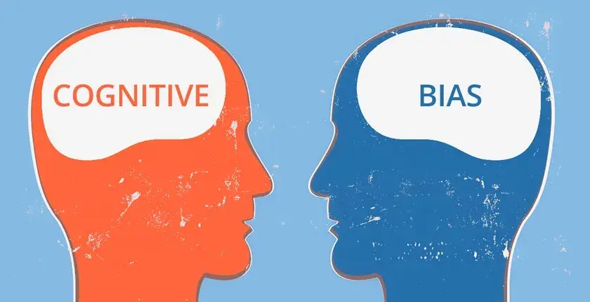 An outline of a head with the word "cognitive" written as the brain facing another outline of a head with the word "bias" written as the brain