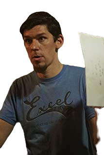 Jared Vineyard holding script pages and giving instructions on set.