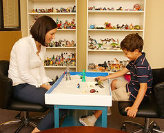 Therapy and child playing with sand table