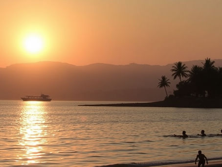 Sunset over a calm sea with a distant boat, swimmers, and silhouetted palm trees on the shore. Sky is orange, creating a serene mood.