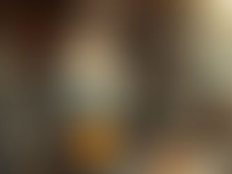 Woman cooking with a large pot over an open fire, surrounded by colorful spices. Stone house setting, warm atmosphere, smoke rising.