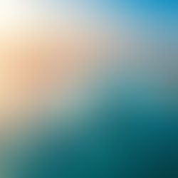 Boats float on turquoise ocean near sandy islands at sunset. Sky transitions from orange to blue, creating a serene atmosphere.