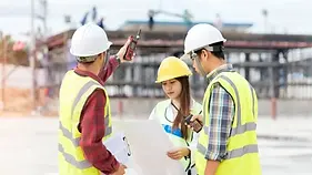Expert witness surveyor analyzing construction dispute documents.webp