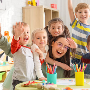 Smiling preschool teacher with happy children waving during class at Great Beginnings Preschool in Glendale, Arizona, helping ease preschool separation anxiety.