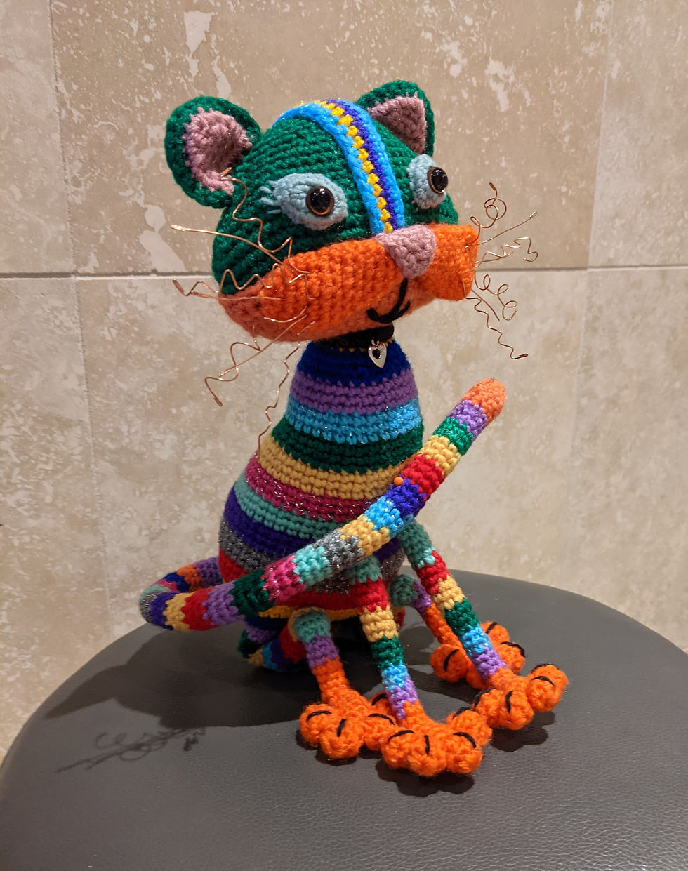Stripey, colourful, cartoon style can sitting on a stool
