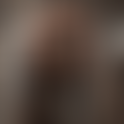 A man holding an ancient key in-between his hands.