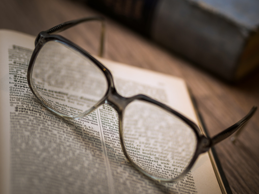 glasses on a book dictionary
