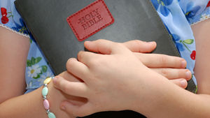 girl holding a bible