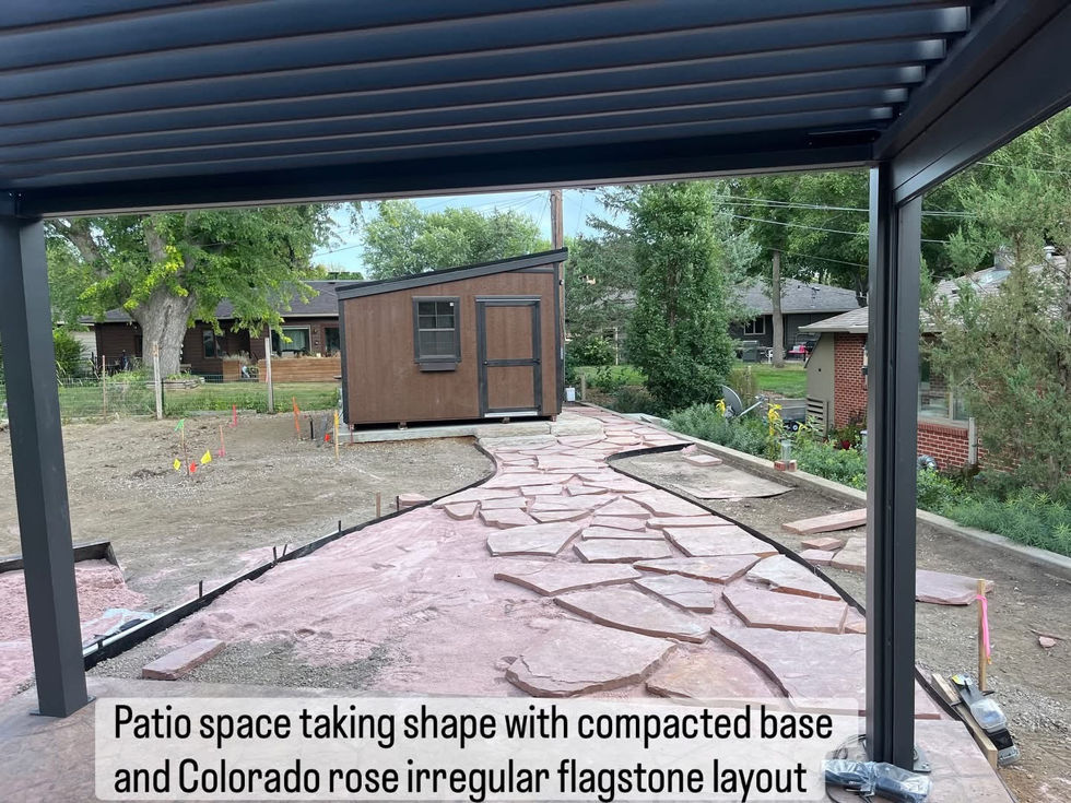 Patio with compacted base and flagstone layout.