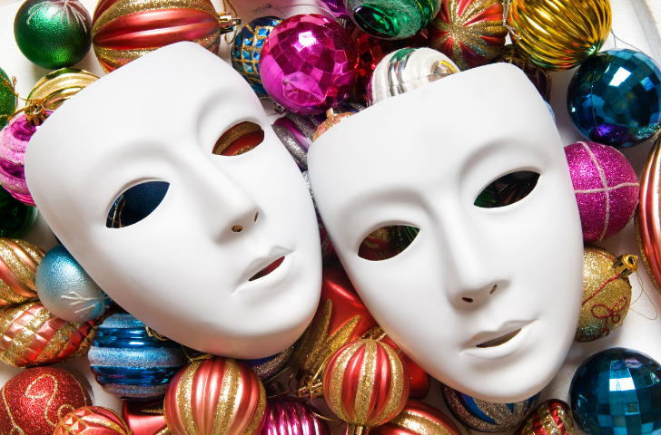 All White Mardi Gras masks sitting on colorful ornaments