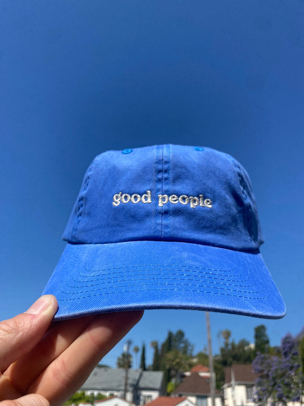 faded bright blue dad hat with "good people" embroidered
