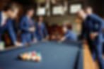 Groom prep playing pool in the library