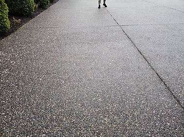 Freshly pressure washed exposed aggregate concrete driveway in Surrey, BC