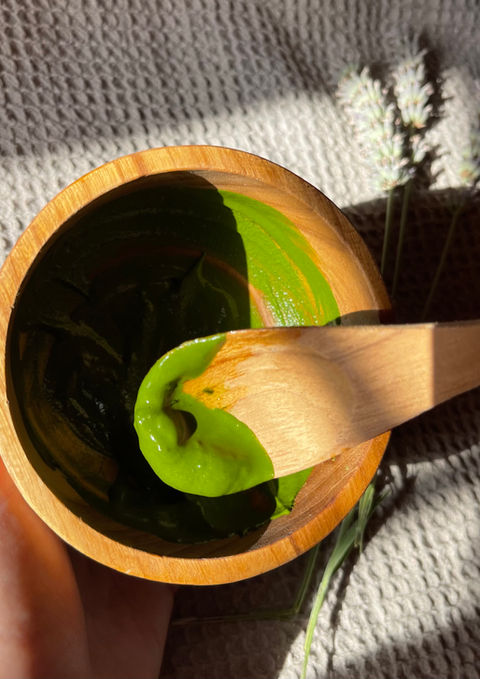 wooden bowl with a green matcha face mask