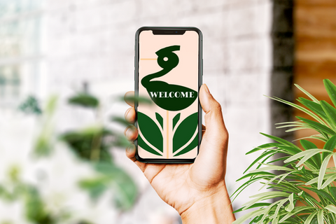 Person holding a phone that is displaying a heron logo.