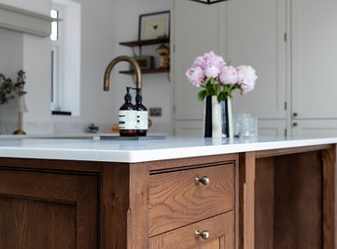 Handmade oak kitchen island with solid surface worktop and hot water tap