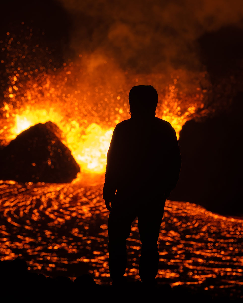 Land of Fire & Ice - Iceland: This photo is taken with a telephoto lens to create the compression effect of the subject standing much closer to the lava.