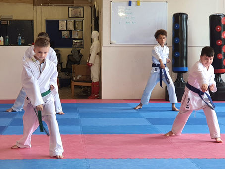 Children taking part in a karate grading focused on confidence and progress
