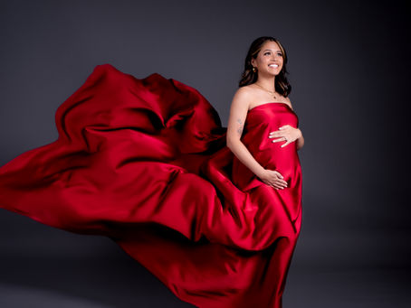 Pregnant woman wearing a flowing dress during a maternity photoshoot in Bangkok.