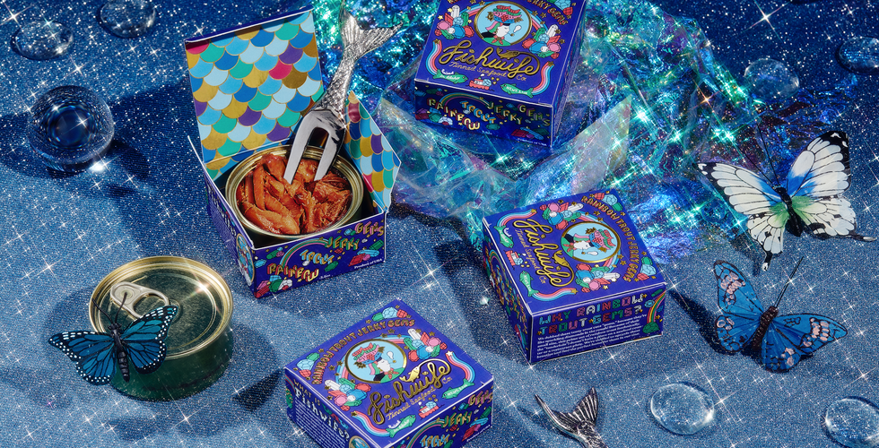 Stylized Fishwife product photography features blue boxes of tinned fish on a sparkly blue set.