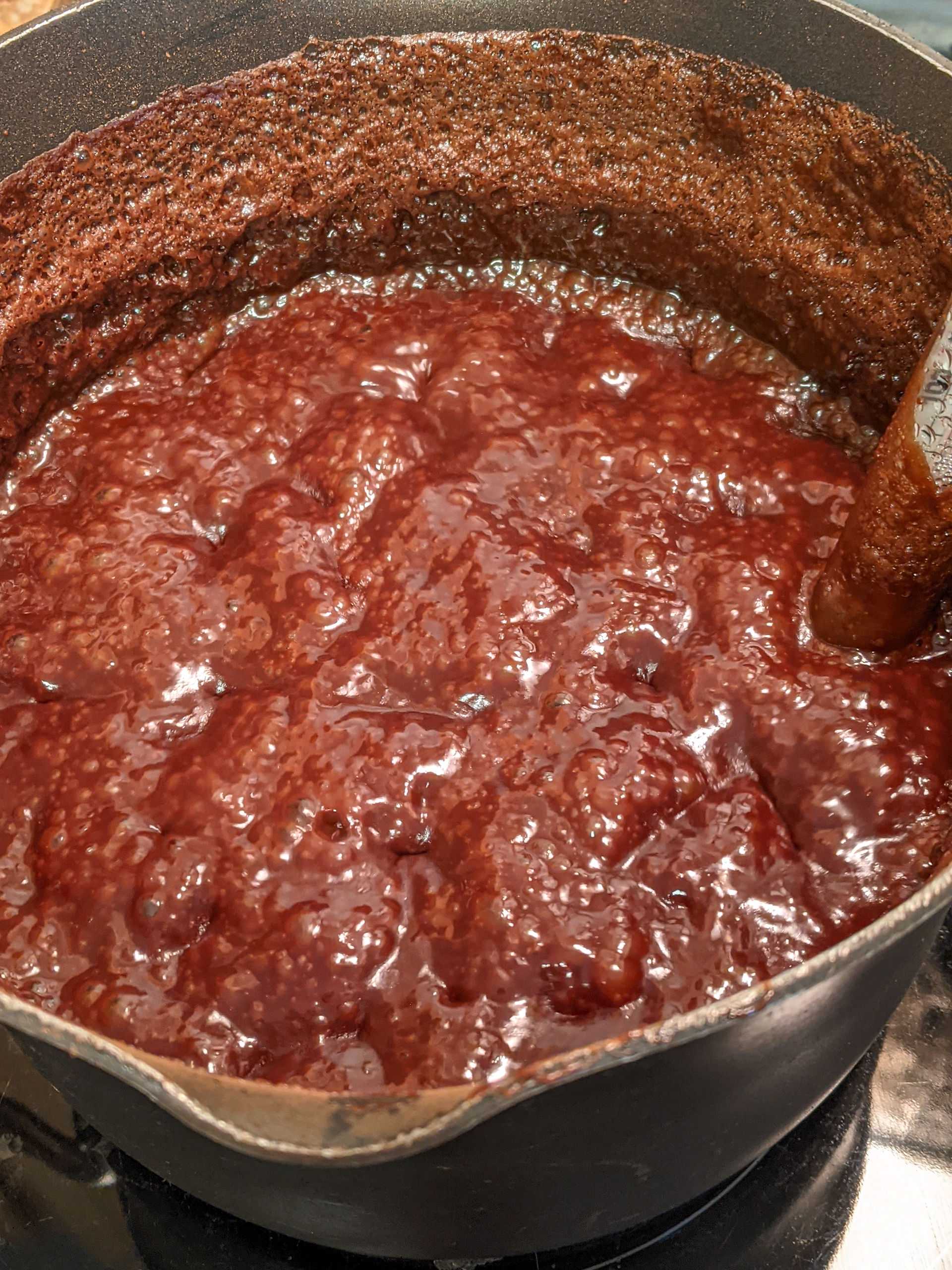 About halfway done. The liquid has reduced substantially and now is a deeper chocolatey color.