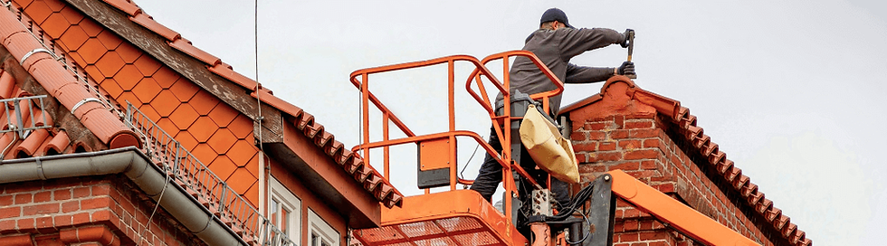 Roofer on mechanical lift plastering terra cotta tiles