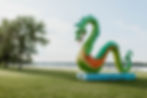 Colorful serpent sculpture at Crosby Memorial Park beside the lake, perfect for a family outing.