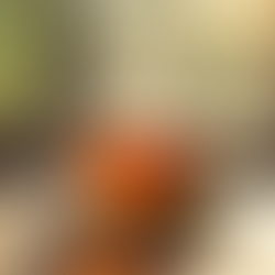 Cup of tea steaming on a table near a window